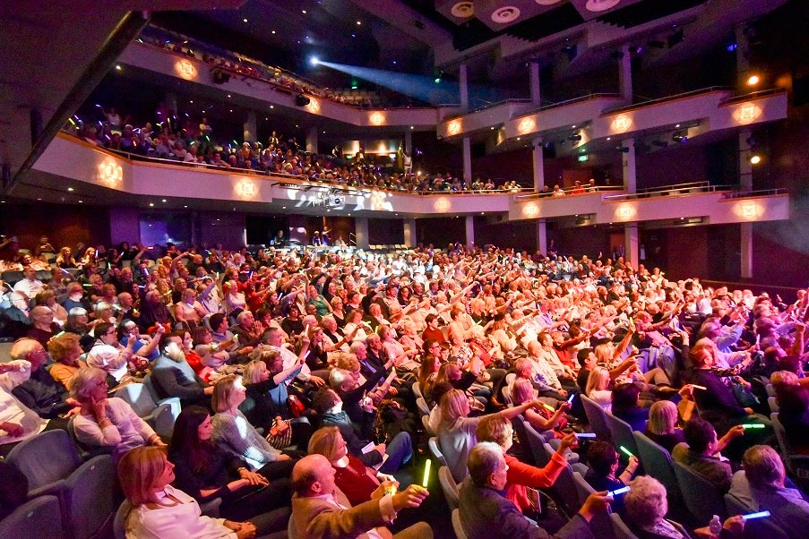 Full Theatre in Woking enjoying Booby Davros' Comedy Spectaular Fundraiser for Woking & Sam Beare Weybridge Hospices