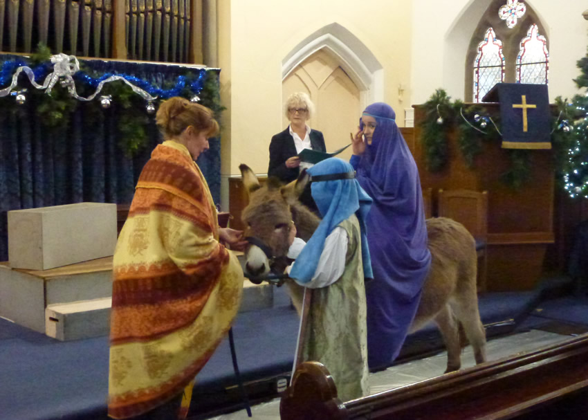 Nativity story and real donkey at Christmas Eve Crib Church Service Weybridge Surrey