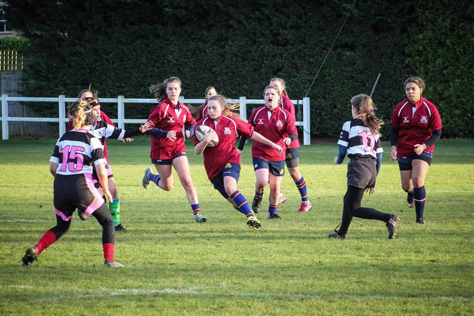 Girls having fun playing rugby at Cobham Bluebirds Club in Elmbridge Surrey