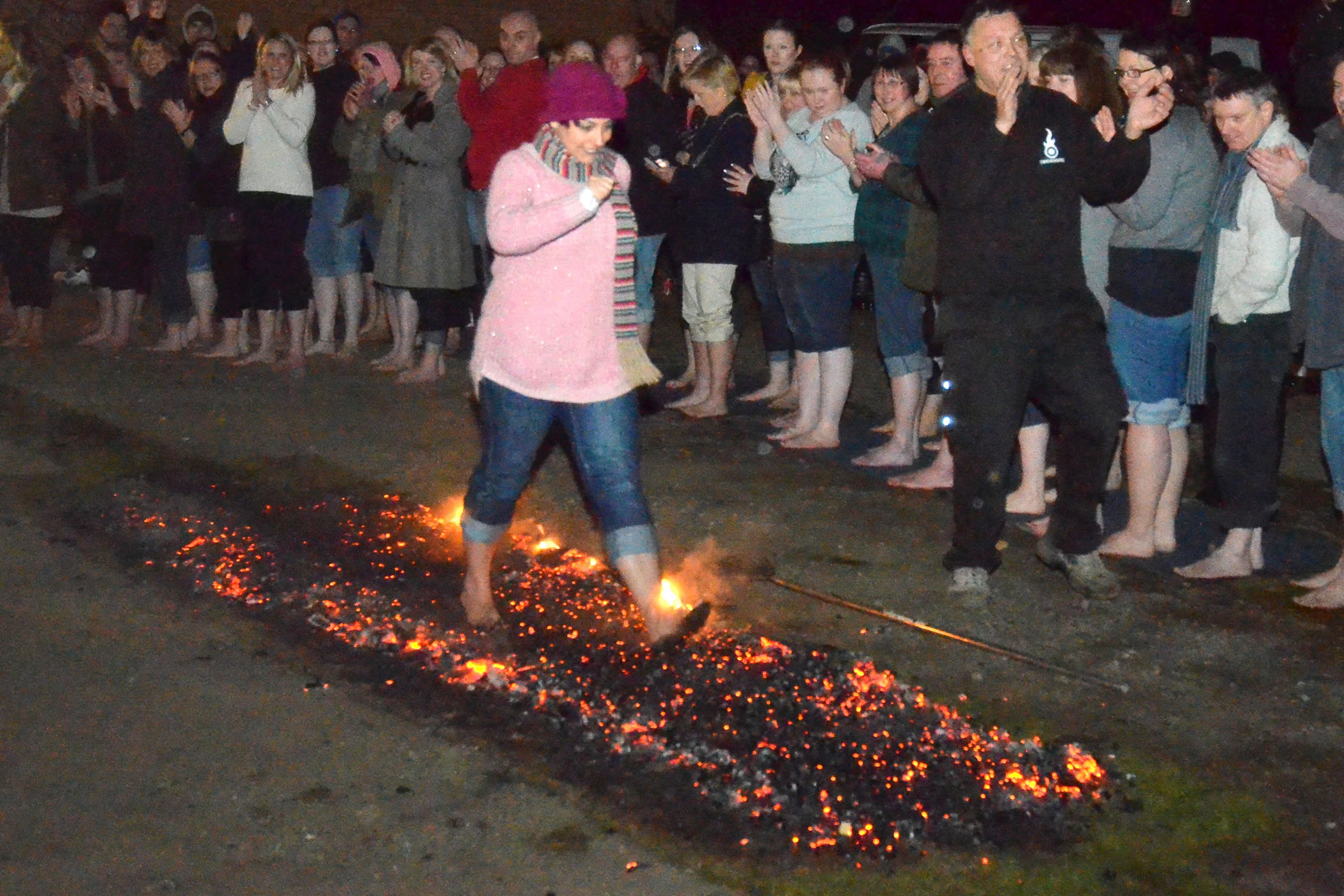 Firewalk at Esher Rugby Club for Princess Alice Hospice - Lady walking over coals