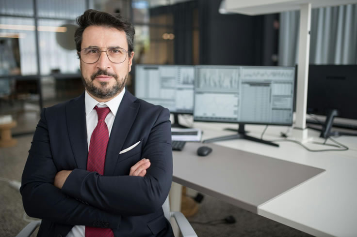 professional man in office arms crossed