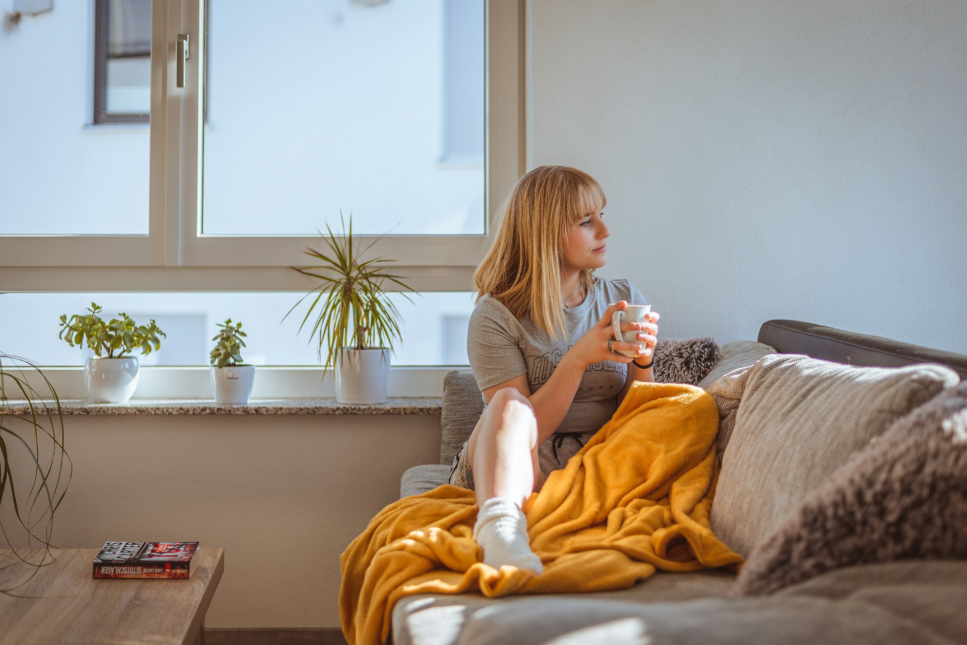 woman relaxing on sofa with coffee woman relaxing on sofa with coffee